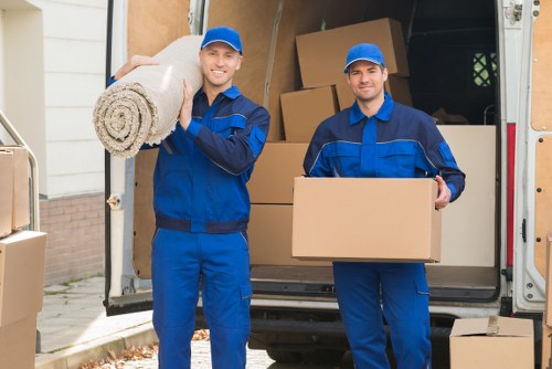 Company van and staff preparing a rubbish removal job at a residential property